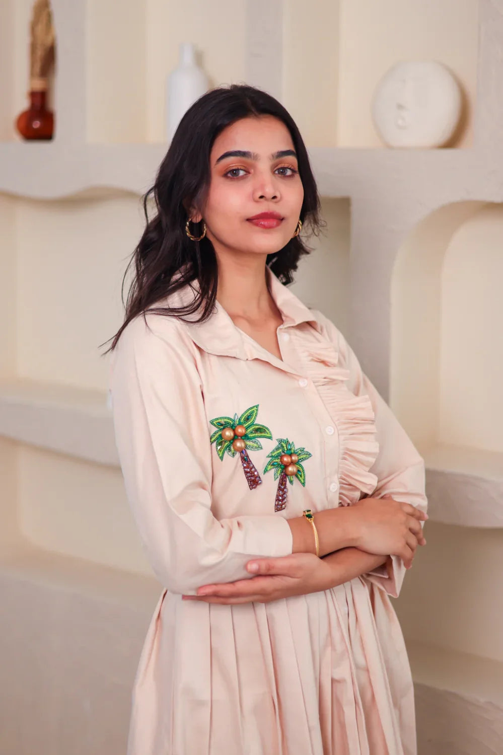 Woman in beige embroidered dress with palm tree motif, stylish everyday outfit