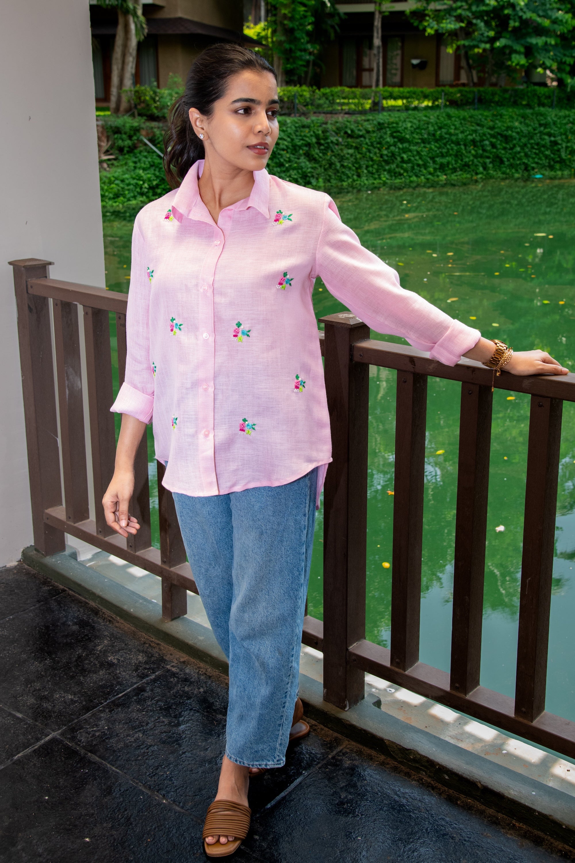 Pink floral embroidered shirt with rolled sleeves, paired with blue jeans, perfect for casual everyday wear.