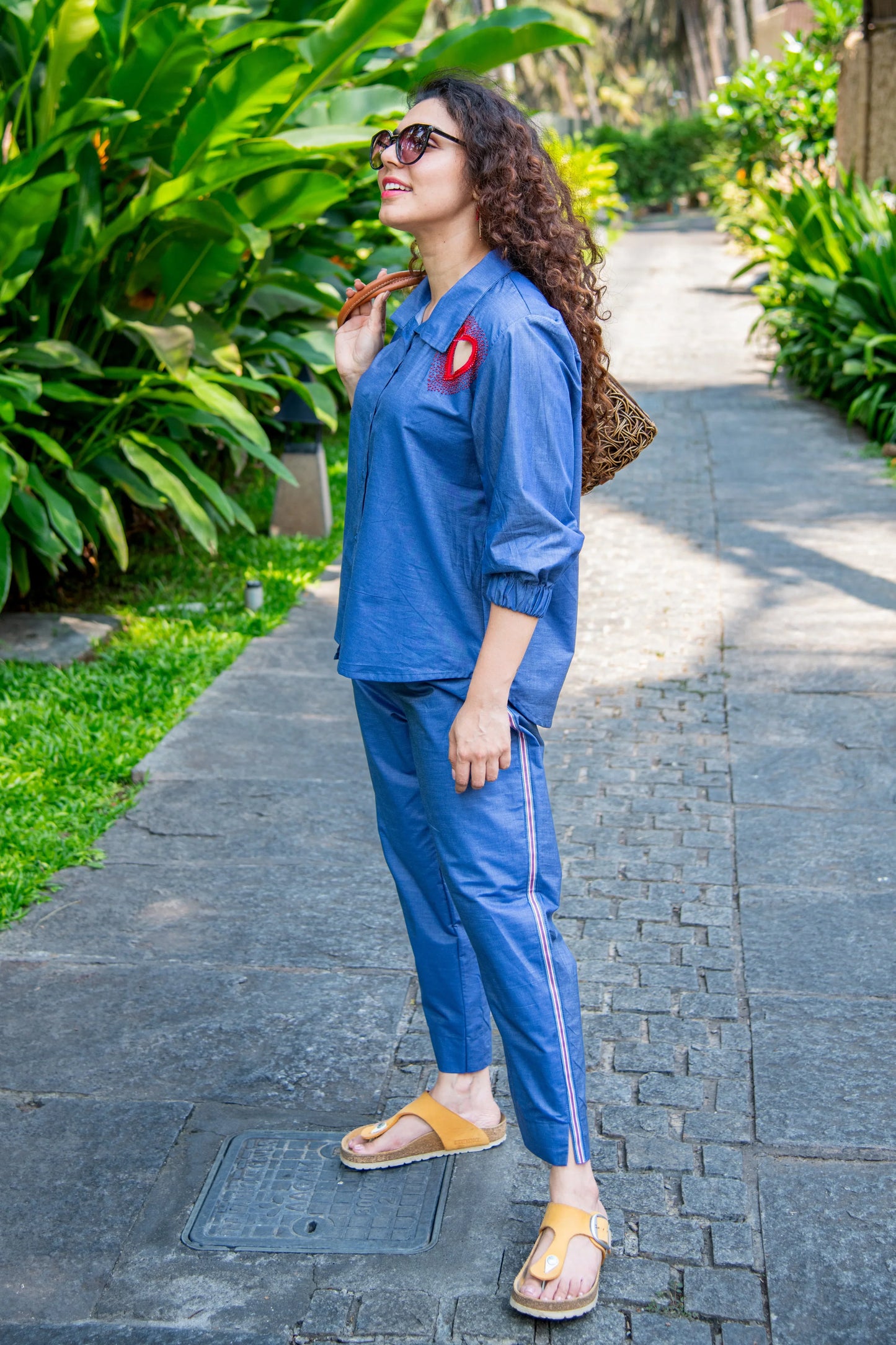 Woman wearing blue co-ord set with embroidery, walking outdoors, casual summer fashion