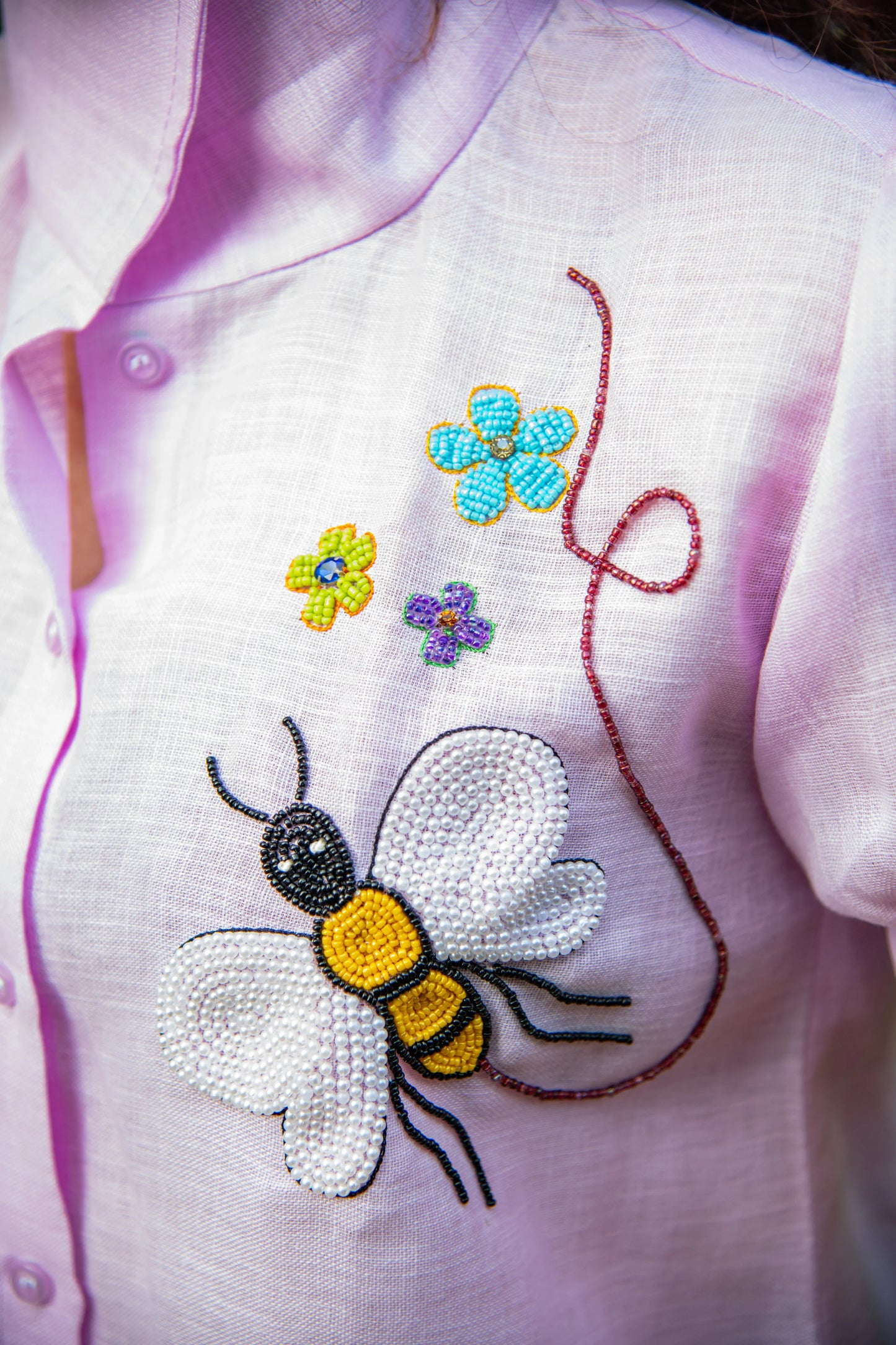 Light pink shirt with beaded bee and flower embroidery detail