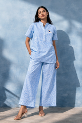 Light blue linen co-ord set with embroidered detail, wide-leg pants, and short sleeves for women