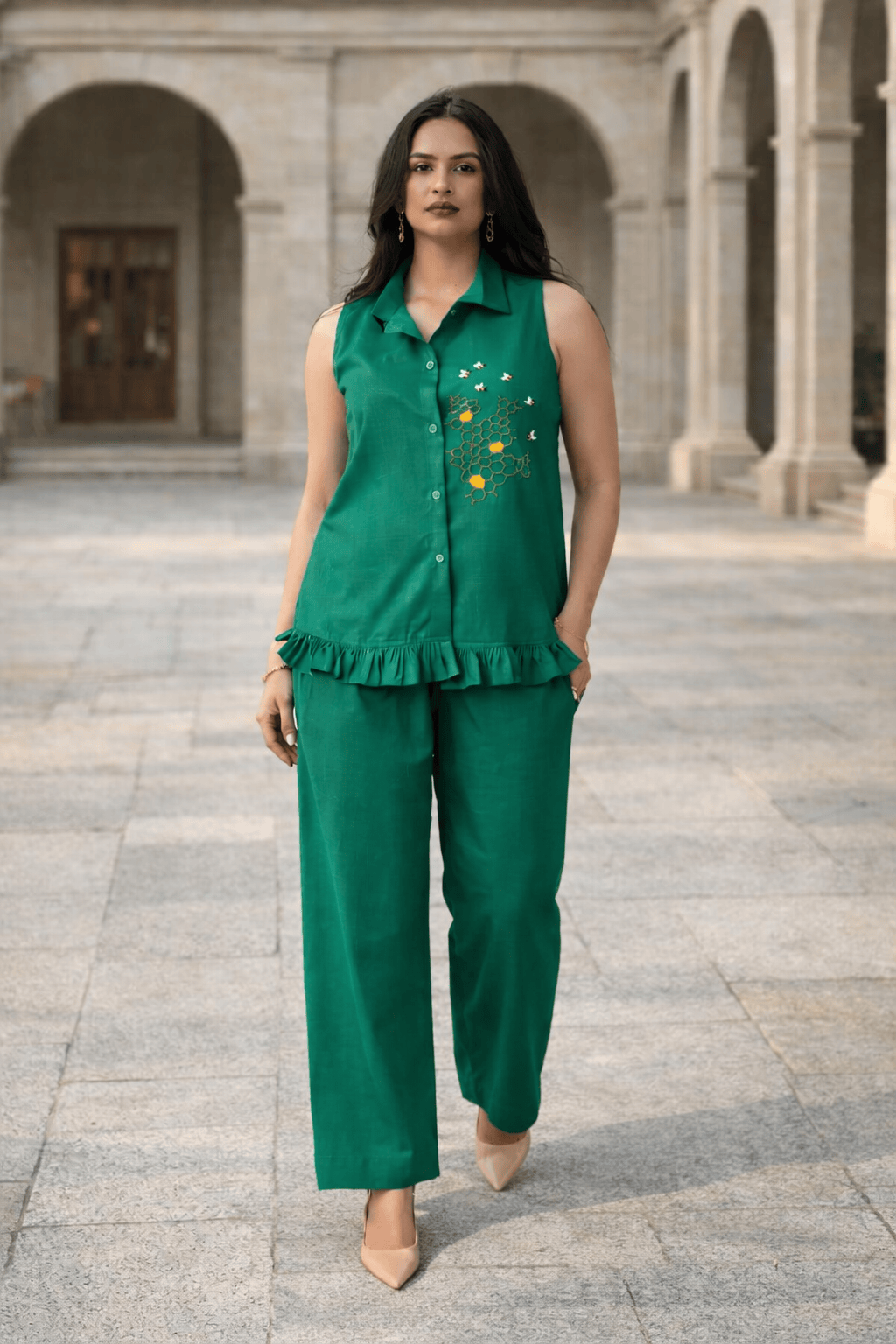 Emerald green sleeveless co-ord set with floral embroidery, ruffle hem, and wide-leg pants for women