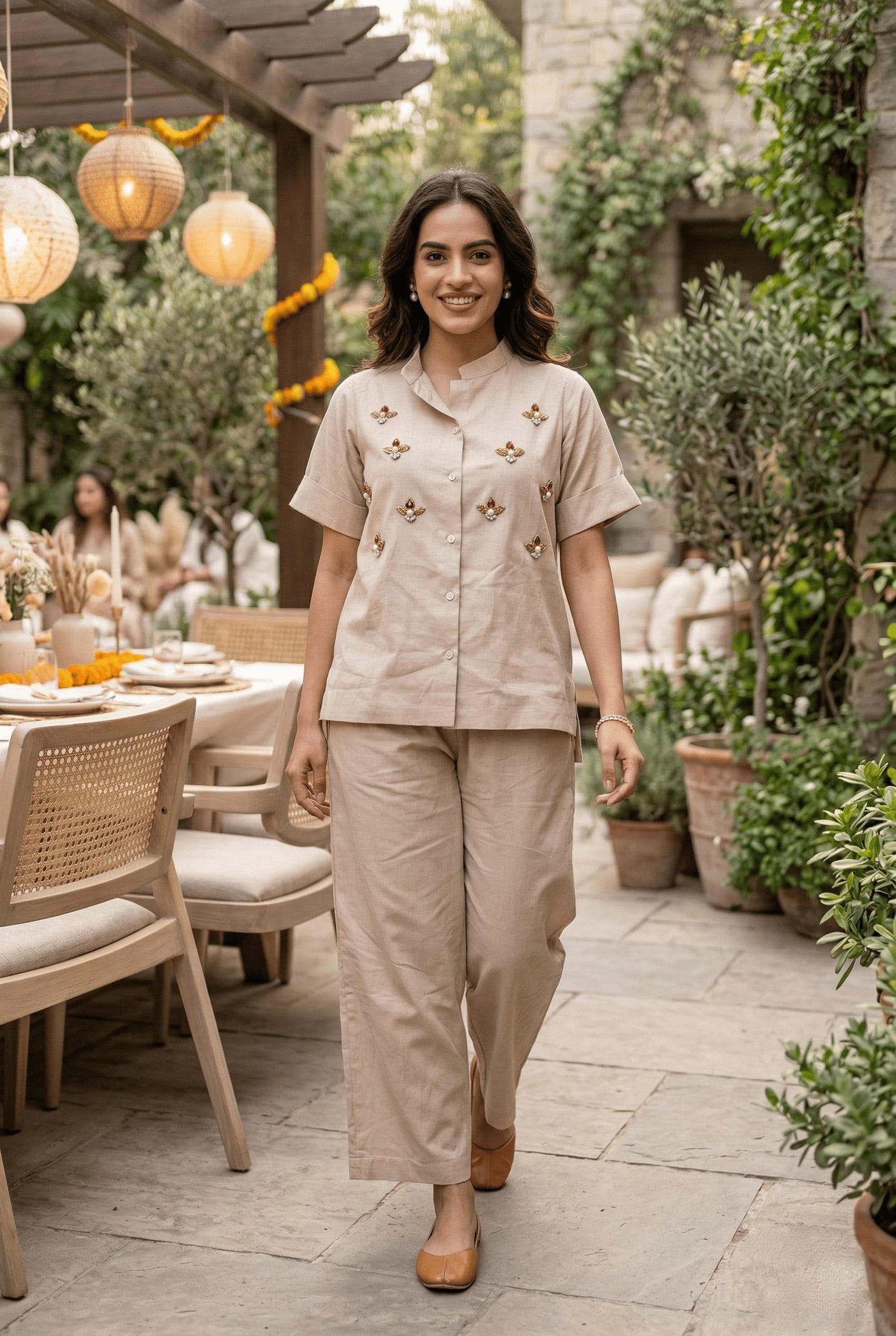 Beige embroidered co-ord set with short sleeves and wide-leg pants, styled for outdoor gatherings