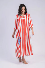 Woman in red and white striped maxi dress with three-quarter sleeves and blue fish patch