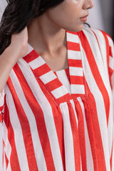 Close-up of woman wearing red and white vertical striped V-neck dress