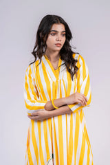 Woman in a yellow and white striped dress with three-quarter sleeves, posing indoors