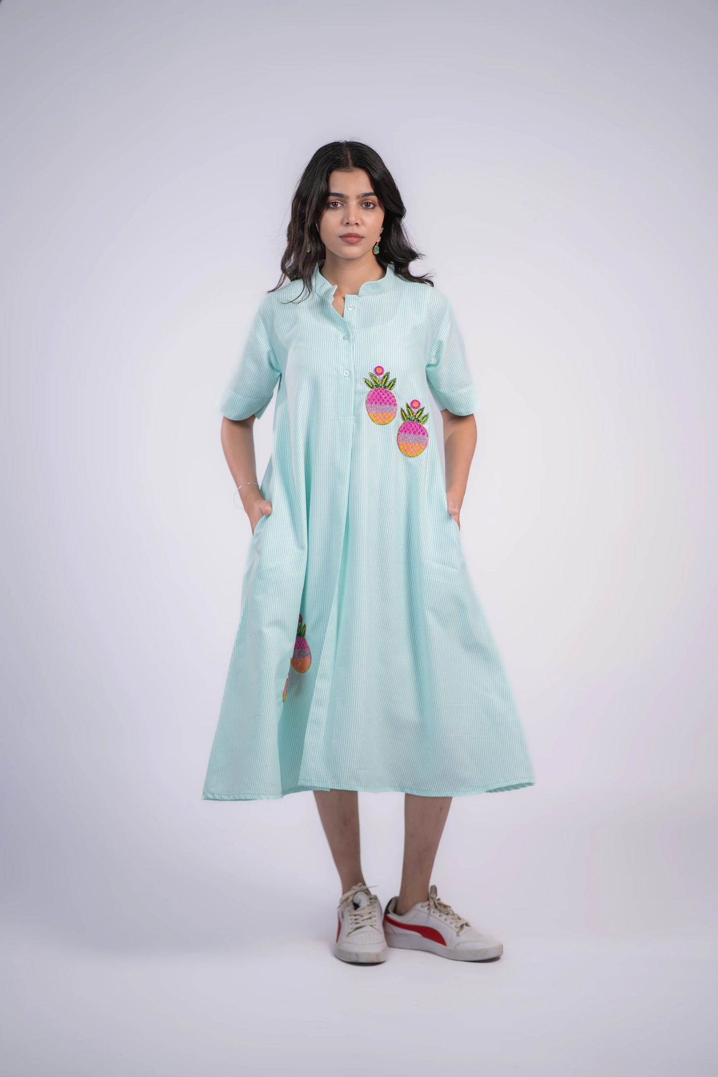 Mint green striped shirt dress with pineapple embroidery, paired with white sneakers for casual style.