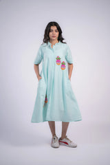 Mint green striped shirt dress with pineapple embroidery, paired with white sneakers for casual style.