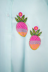 Beaded pineapple embroidery on striped women's shirt, vibrant pink and green design