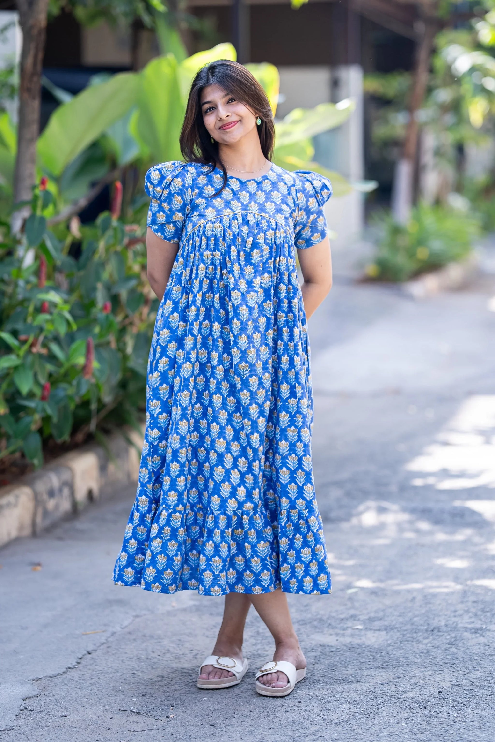 Blue floral midi dress with puff sleeves, perfect for casual outings and everyday wear.