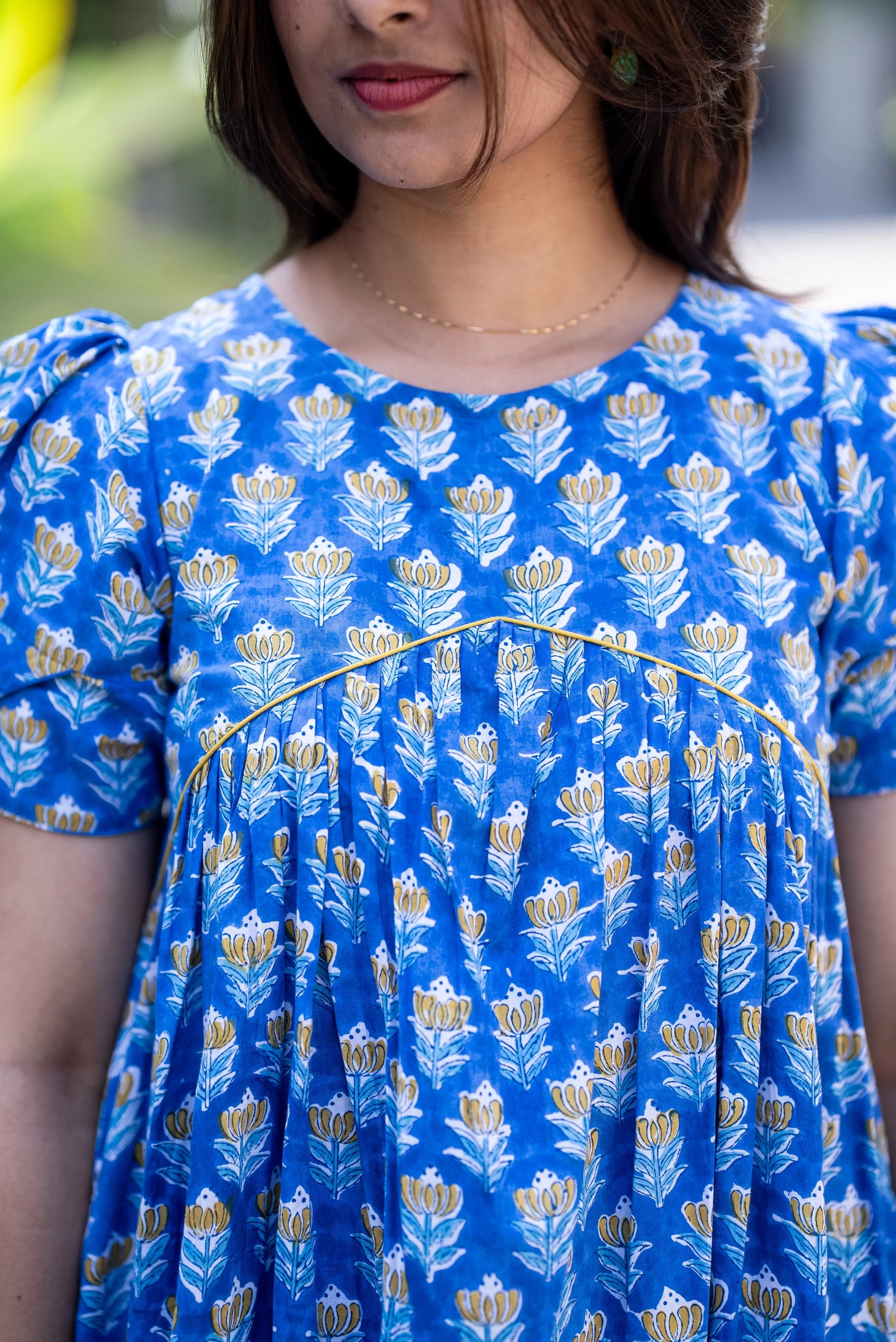 Blue floral dress with puff sleeves and yellow trim, perfect for trendy women's everyday styles.
