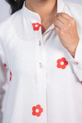 White kurta with red floral print and mandarin collar, front button detail, close-up