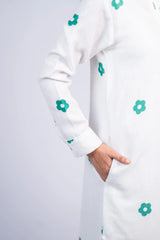 White long sleeve women’s dress with green floral prints and hand in pocket