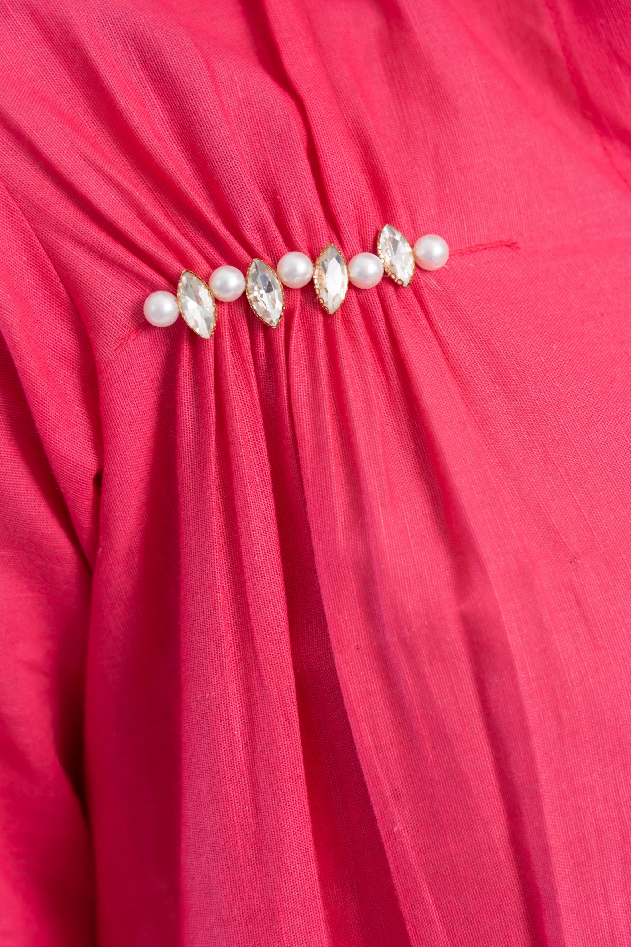 Pink dress with pearl and crystal embellishments, trendy women's fashion detail