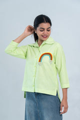 Lime green button-down shirt with rainbow beaded embroidery, paired with denim skirt for casual women's fashion