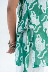 Green dress with white tiger print, tie waist, and silver bracelet