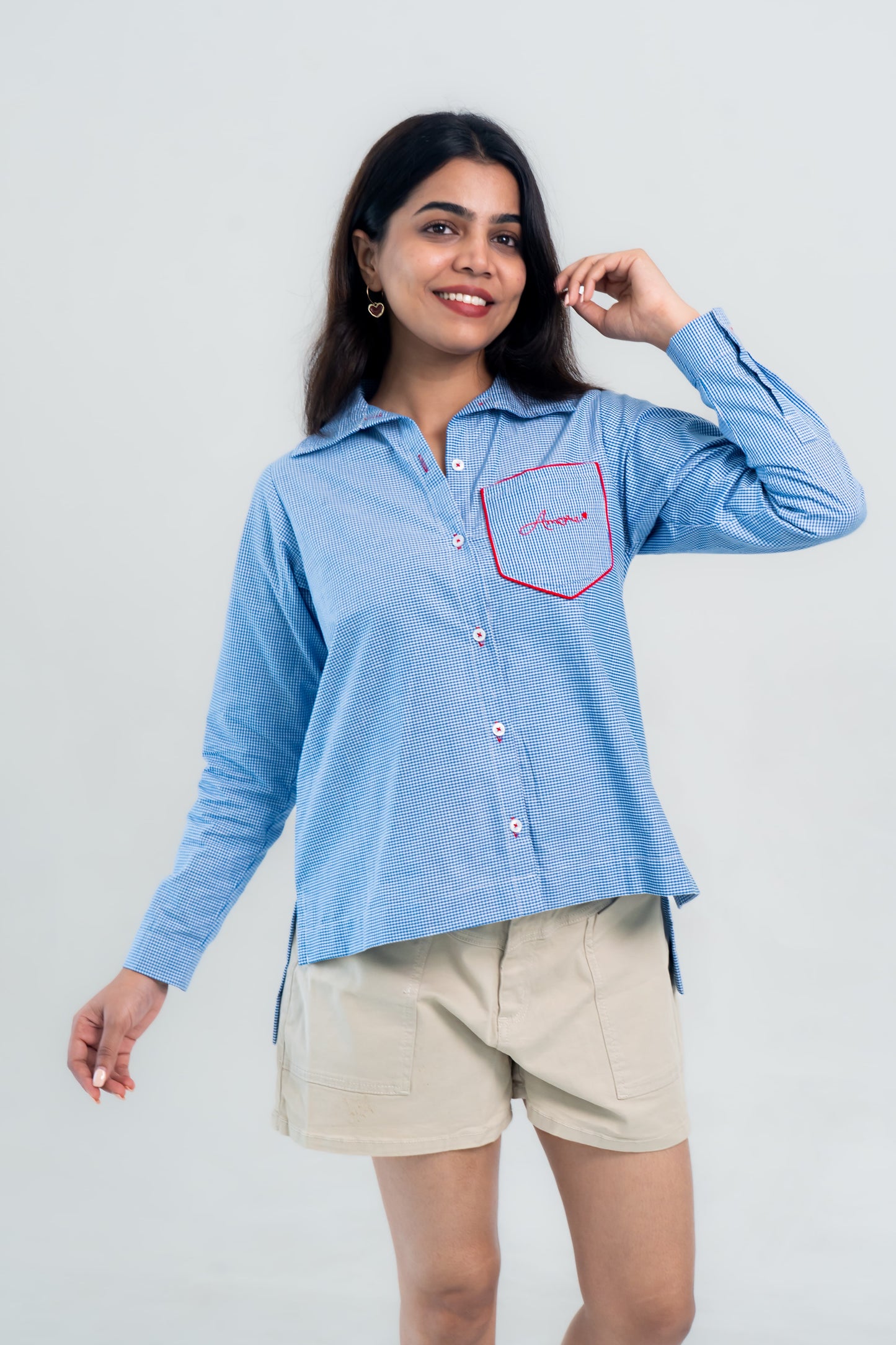 Blue gingham shirt with red 'Amore' embroidery, paired with beige shorts for casual everyday wear.