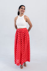Red checkered maxi skirt with white knit crop top, stylish women's fashion