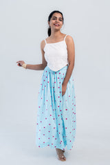 Woman in white eyelet top and blue striped heart print skirt, stylish co-ord set for everyday wear