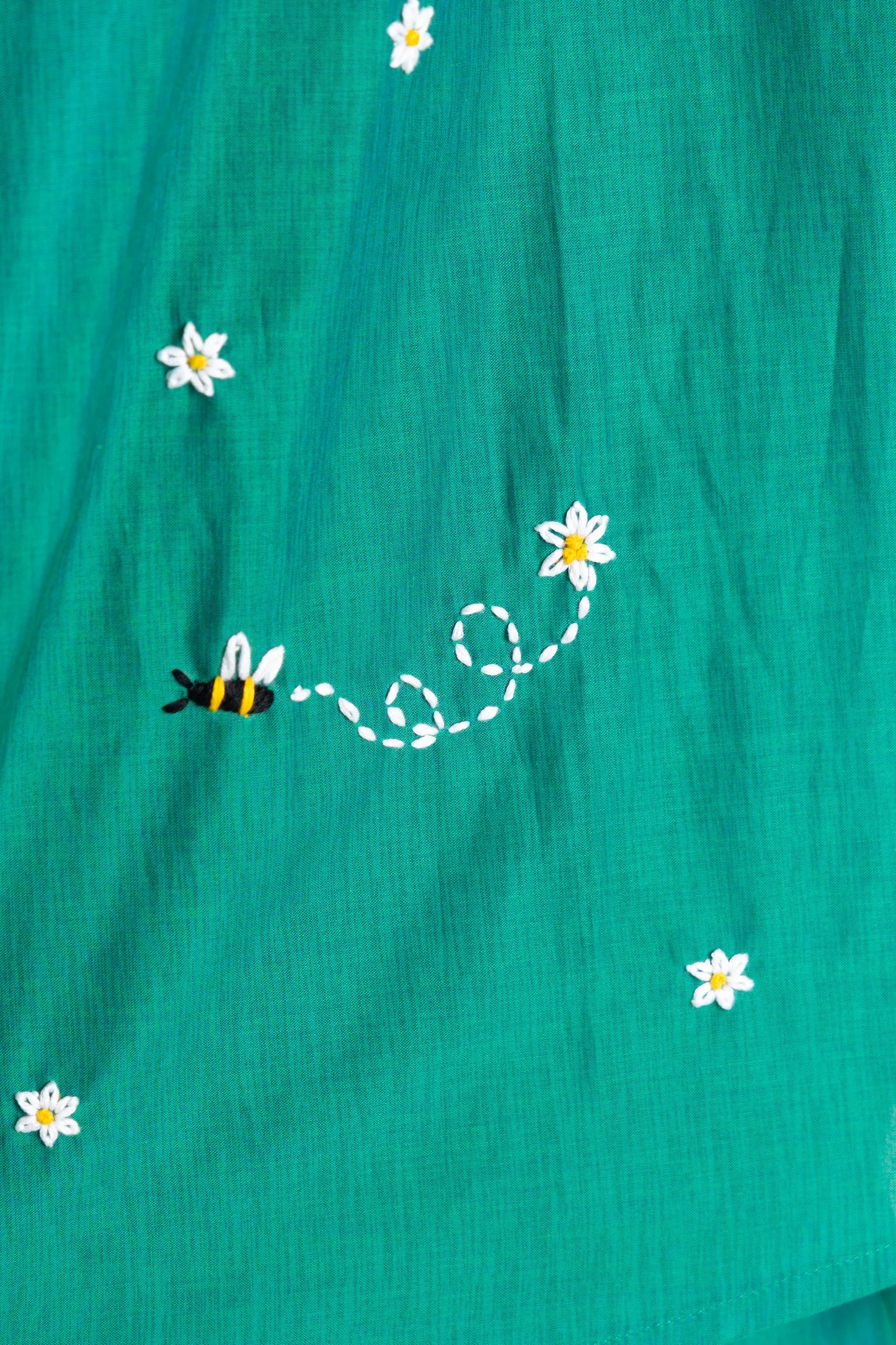 Teal dress with embroidered bee and daisy flowers, trendy women's fashion detail