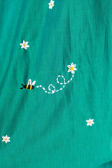 Teal dress with embroidered bee and daisy flowers, trendy women's fashion detail