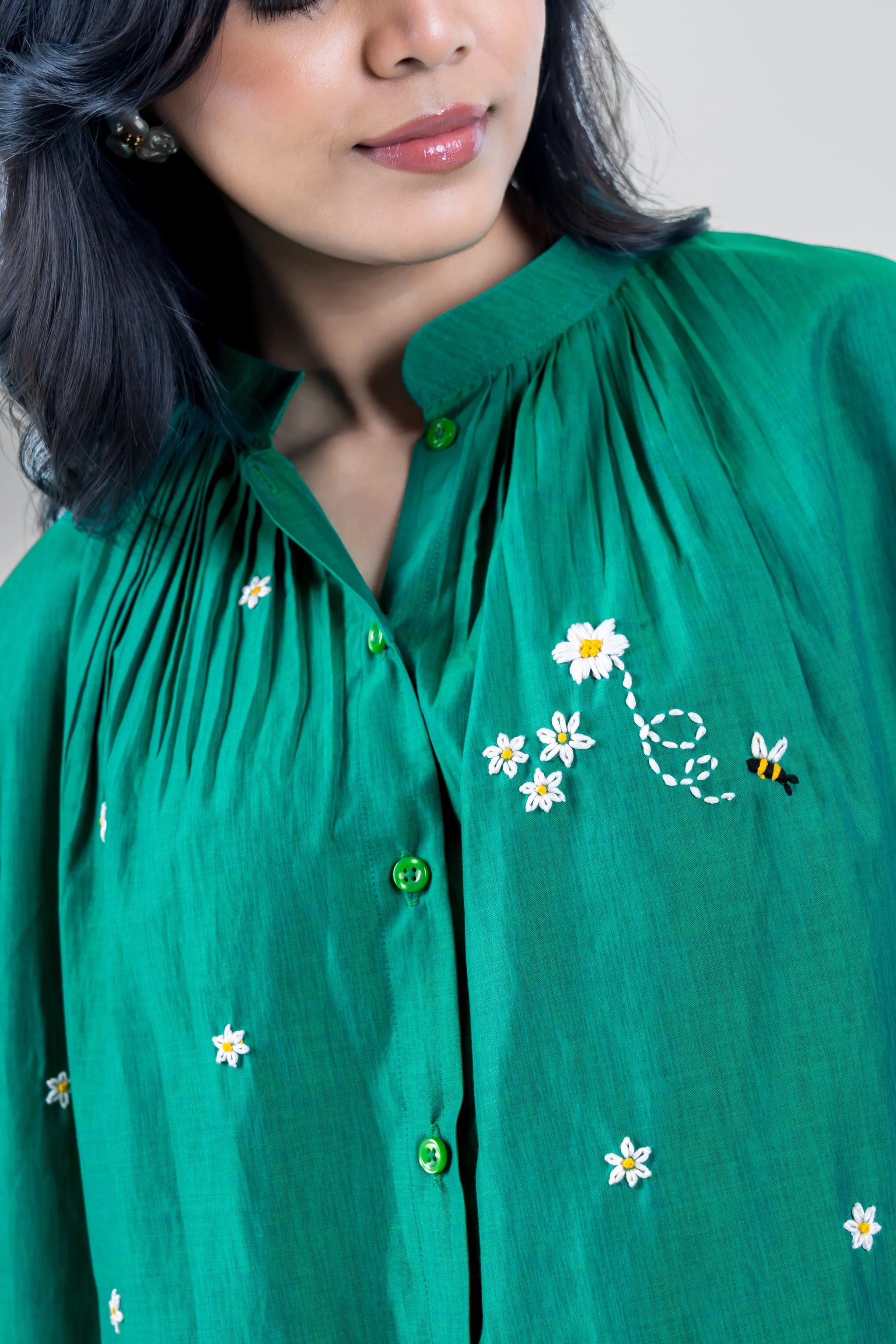 Green embroidered blouse with daisy and bee details, stylish women's fashion