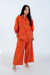 Orange embroidered co-ord set with wide-leg pants and button-up top for women