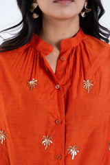 Orange shirt with palm tree sequin embroidery and button front