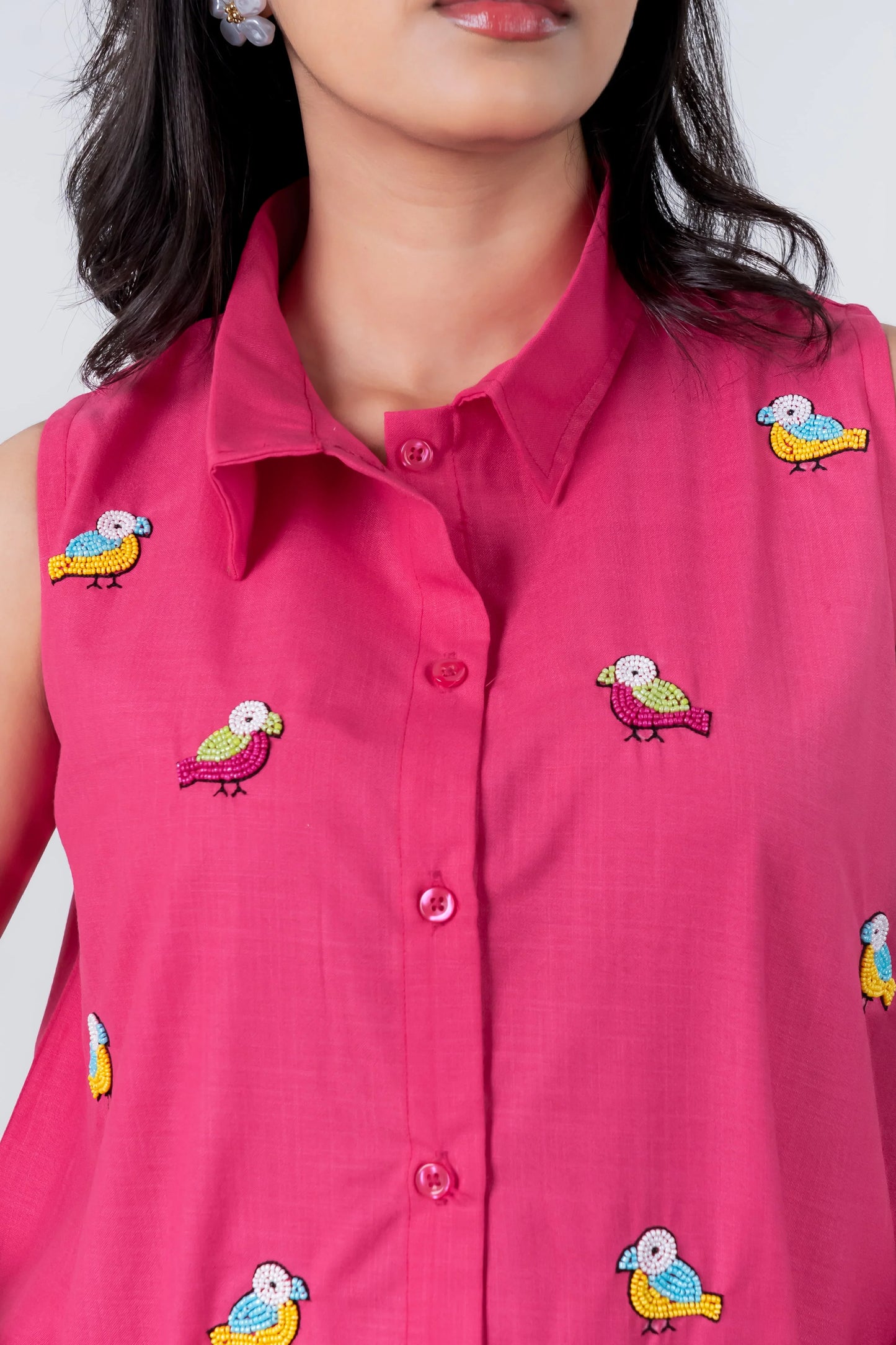 Pink sleeveless shirt with colorful beaded bird embroidery, button front, collar detail