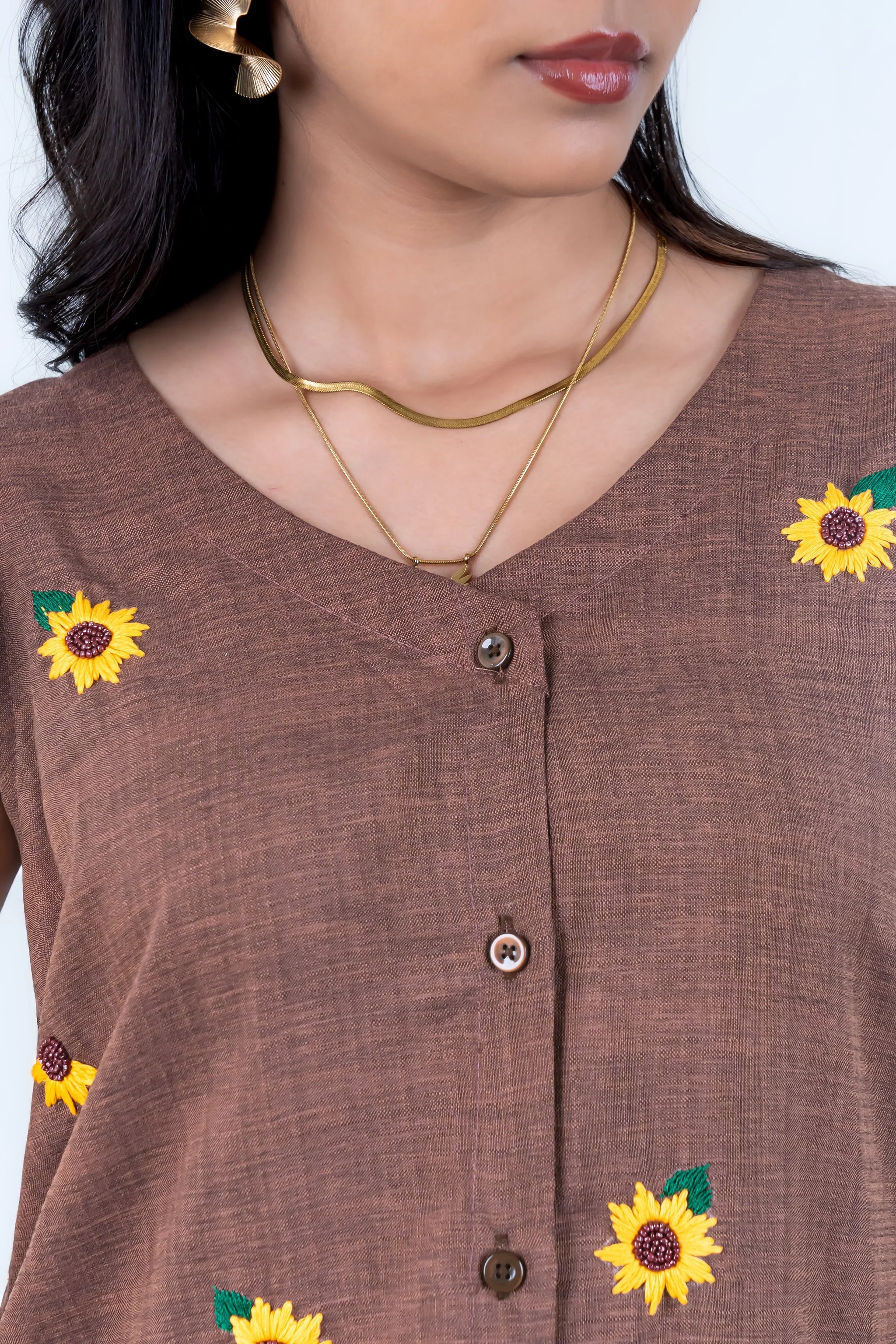 Brown button-up dress with embroidered sunflowers, gold necklaces, and statement earrings for women's fashion