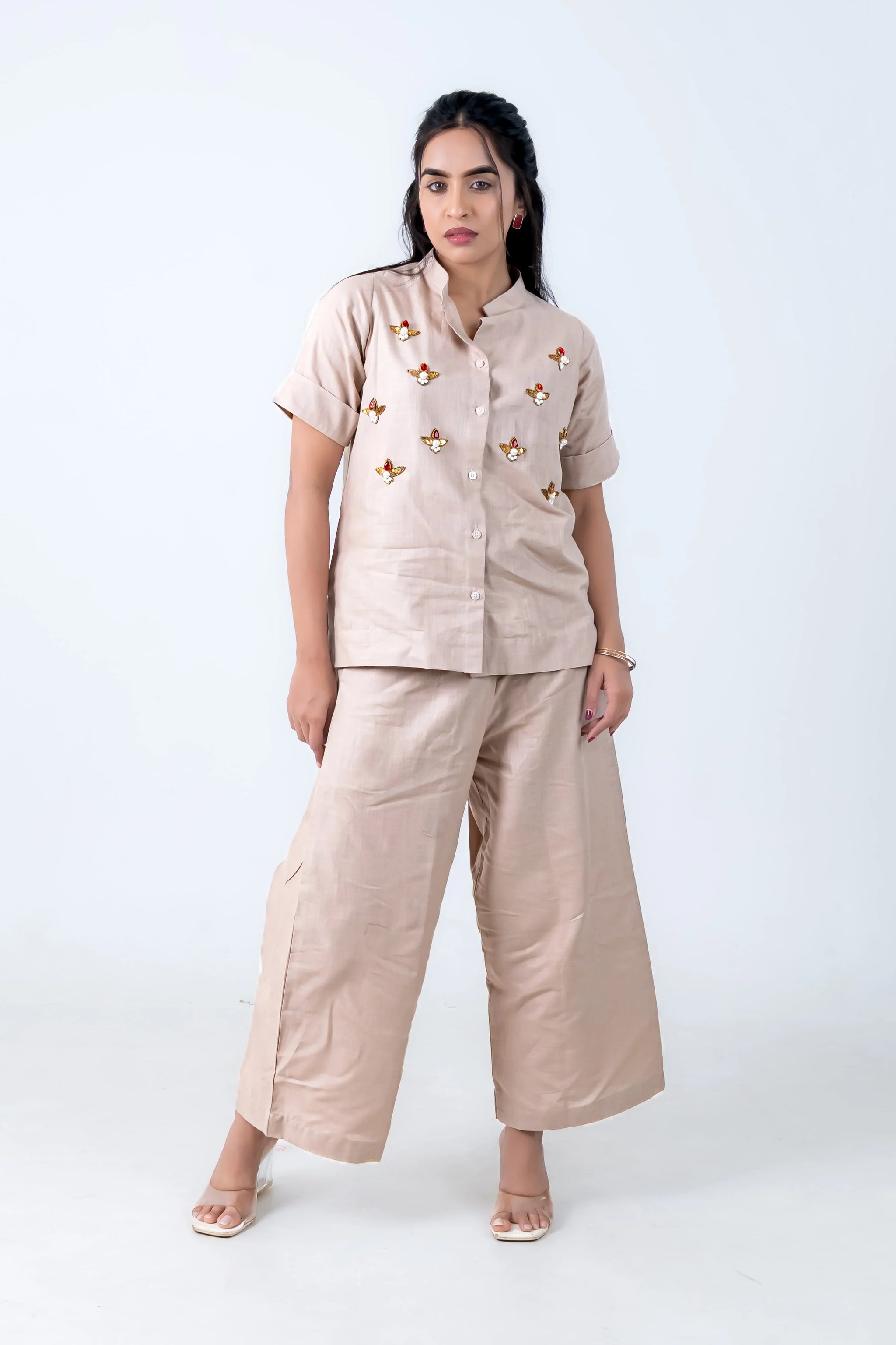Beige linen co-ord set with bee embroidery, wide-leg pants, and button-up top for women