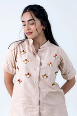 Beige button-down dress with gold bee embroidery and pearl details, stylish women's fashion