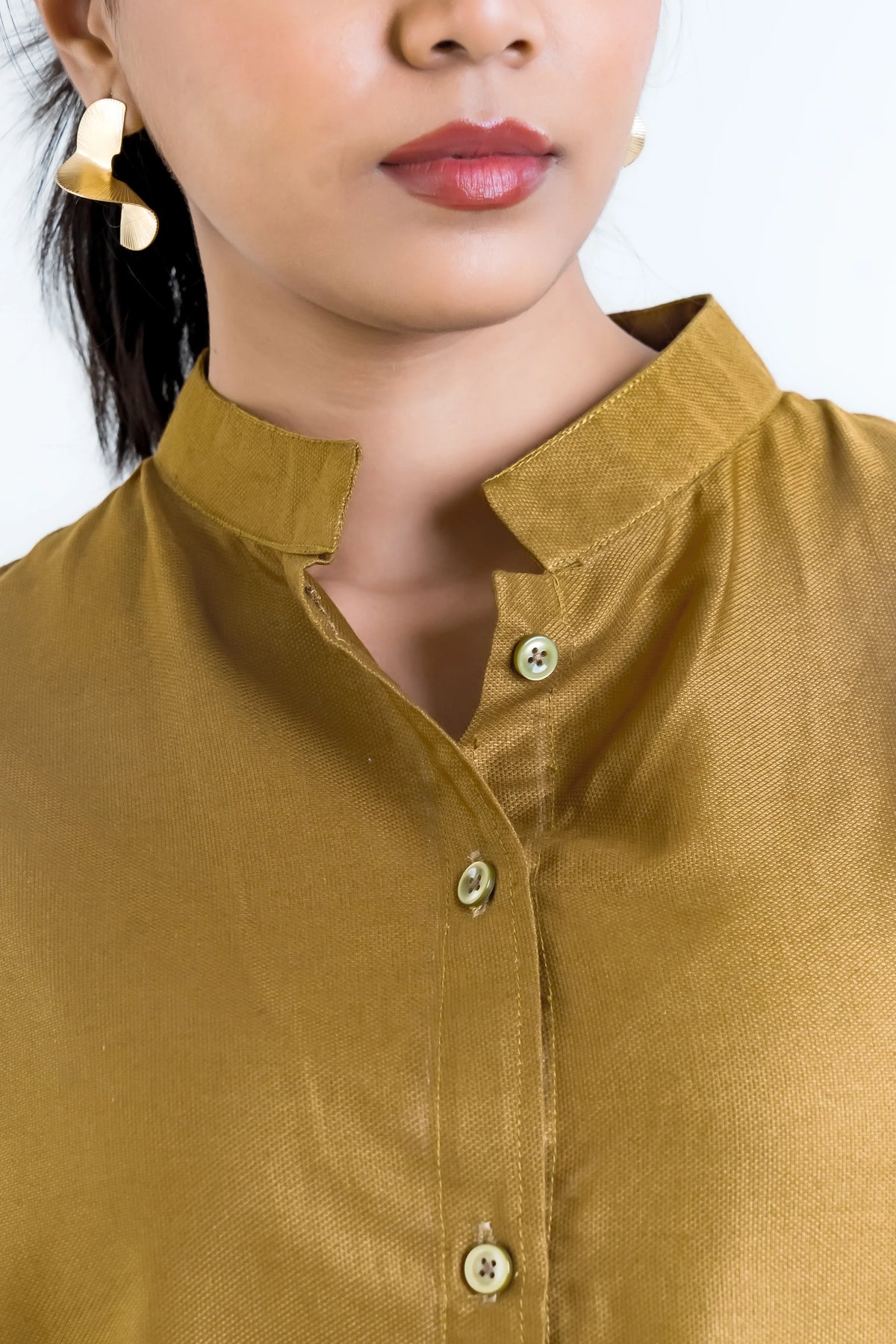 Mustard yellow button-up blouse with collar and gold statement earrings, stylish women's fashion