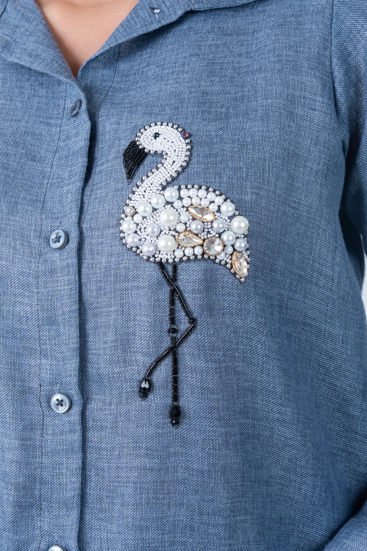 Blue shirt with beaded flamingo embellishment featuring pearls and rhinestones