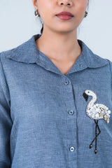 Blue button-up shirt with beaded flamingo embellishment, stylish women's fashion