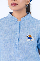 Light blue shirt with beaded poodle embroidery and button front design