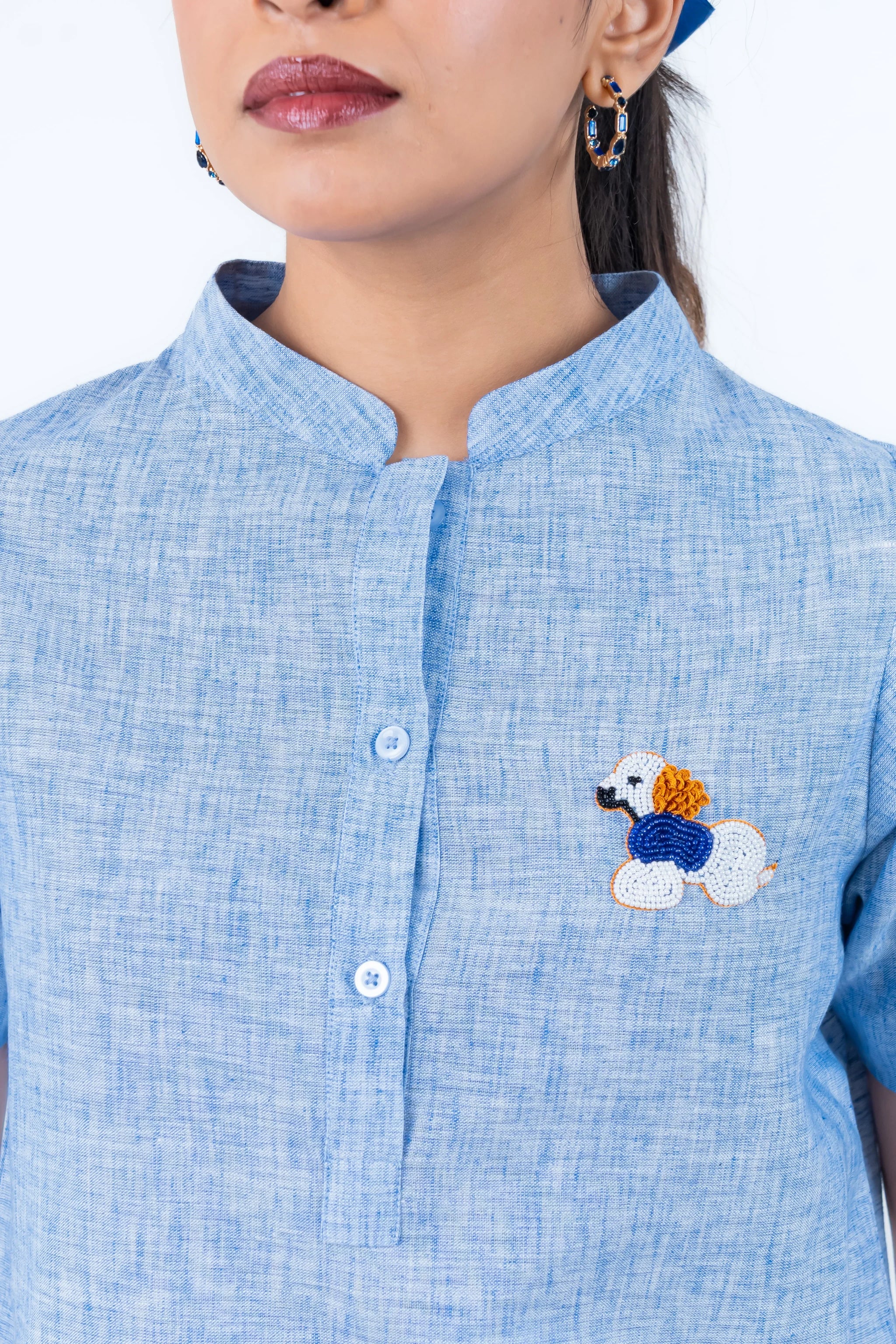 Light blue shirt with beaded poodle embroidery and button front design