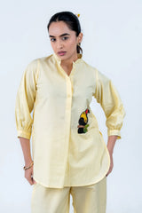 Yellow button-down shirt with beaded toucan embroidery, long sleeves, paired with matching pants for women's co-ord set