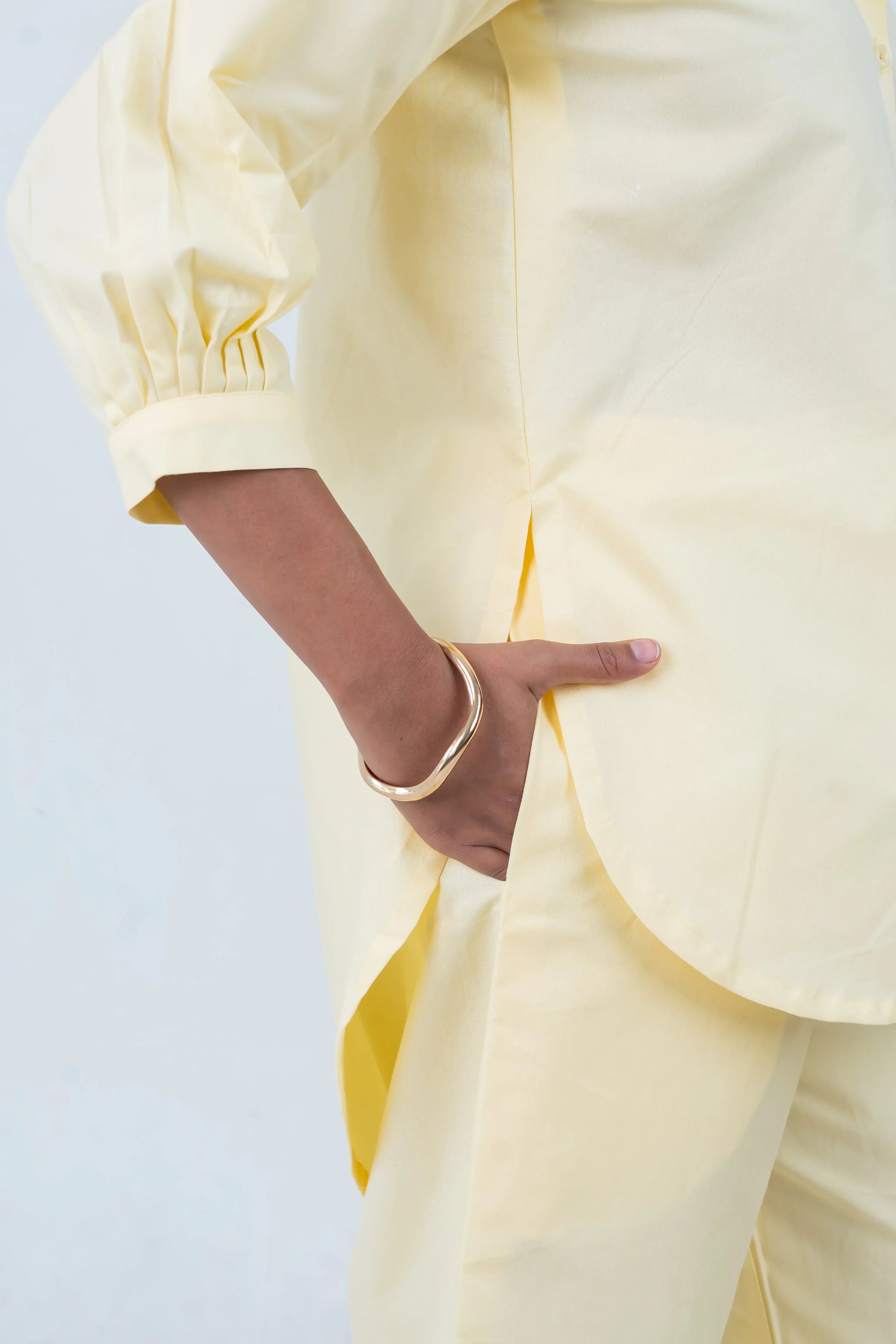 Pale yellow puff sleeve shirt with gold bangle, stylish women's fashion