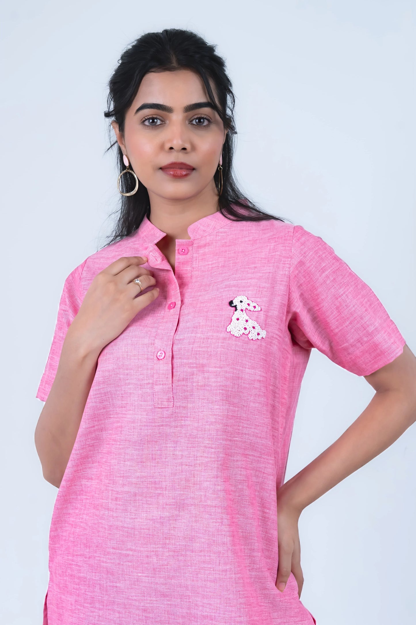 Pink women's kurta with sequin dog embroidery, short sleeves, and button front design