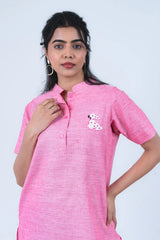 Pink women's kurta with sequin dog embroidery, short sleeves, and button front design