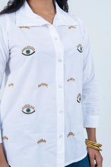 White shirt with embroidered eye and crown details, stylish women's fashion