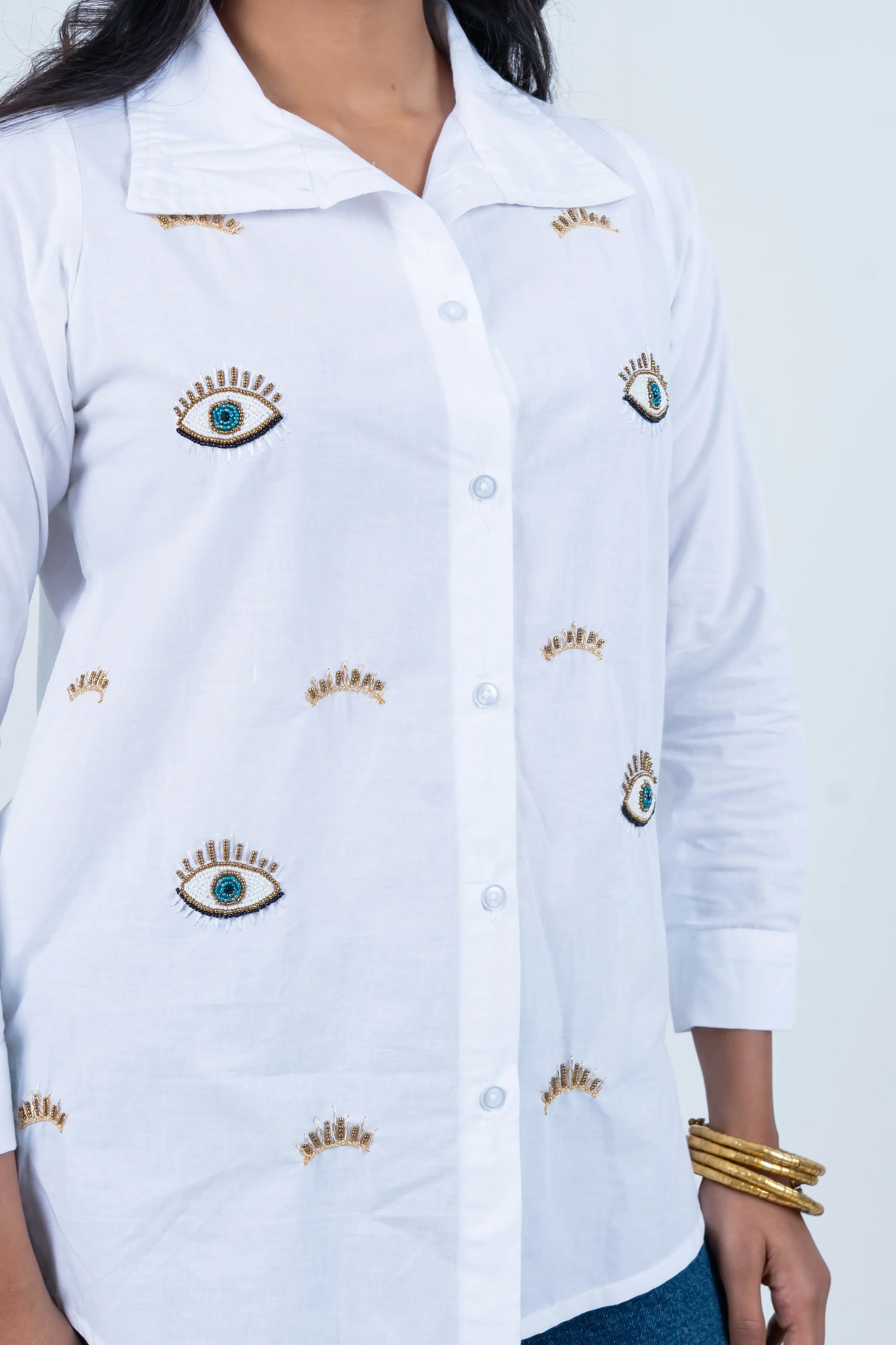 White shirt with embroidered eye and crown details, stylish women's fashion