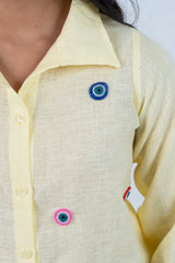 Yellow shirt with colorful beaded eye embellishments for trendy women's fashion