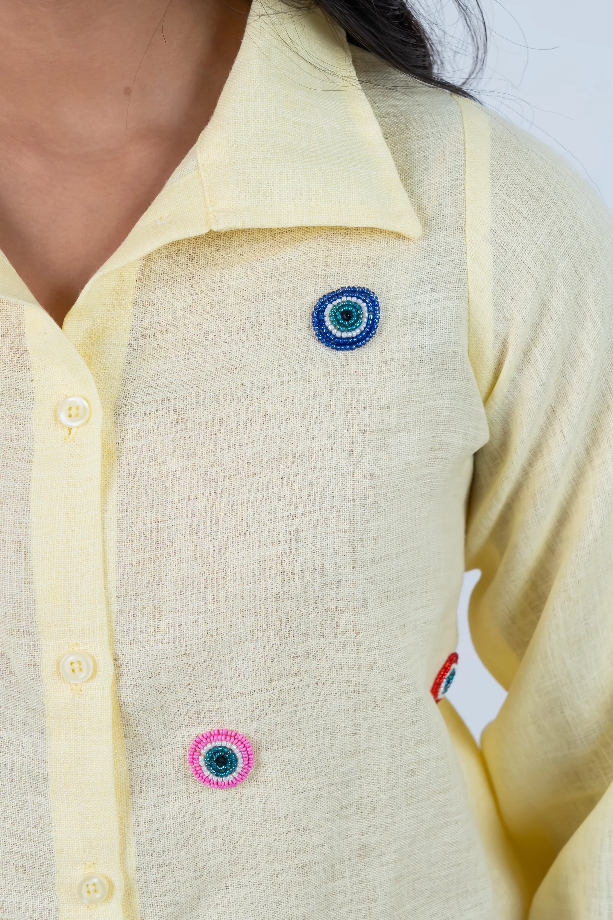 Yellow shirt with colorful beaded eye embellishments for trendy women's fashion