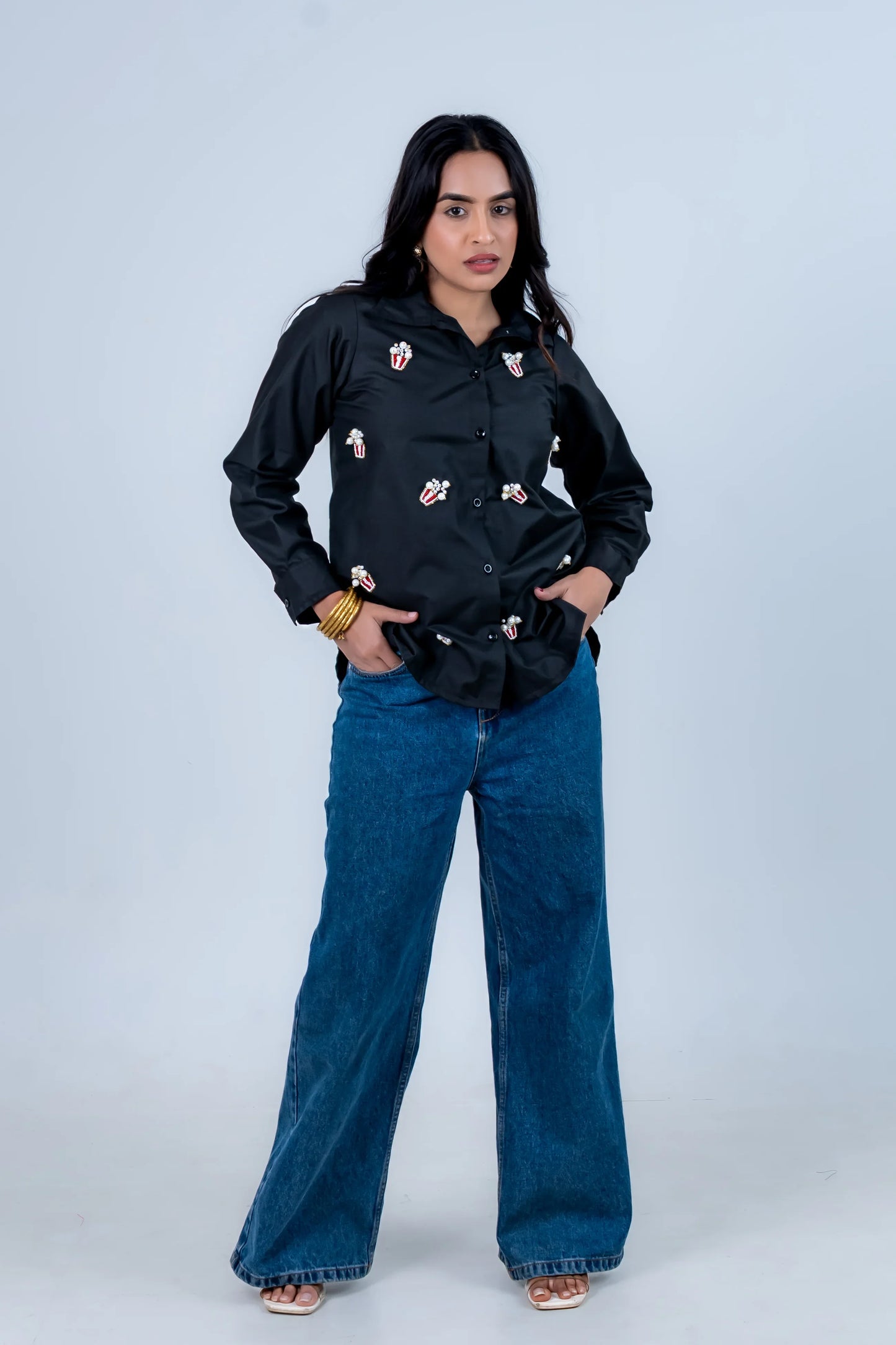 Black popcorn-embellished shirt with wide-leg jeans, trendy women's fashion outfit