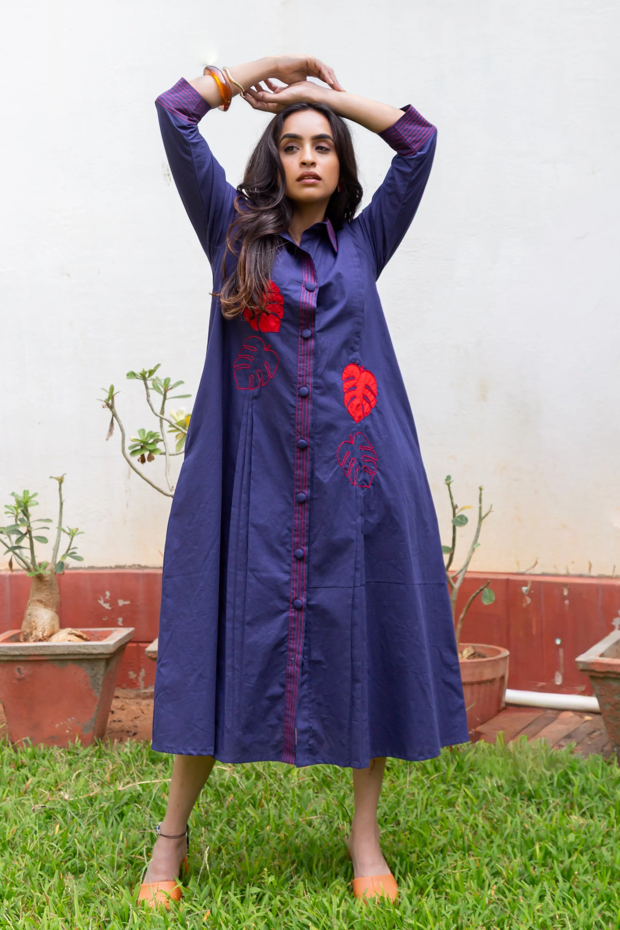 Navy blue dress with red leaf embroidery, button front, and long sleeves for women
