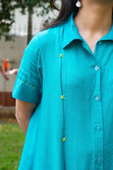 Turquoise shirt dress with yellow embroidery and blue buttons, perfect for casual everyday wear.