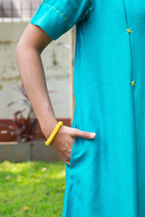 Teal dress with yellow embroidery and matching bracelet, stylish women's fashion