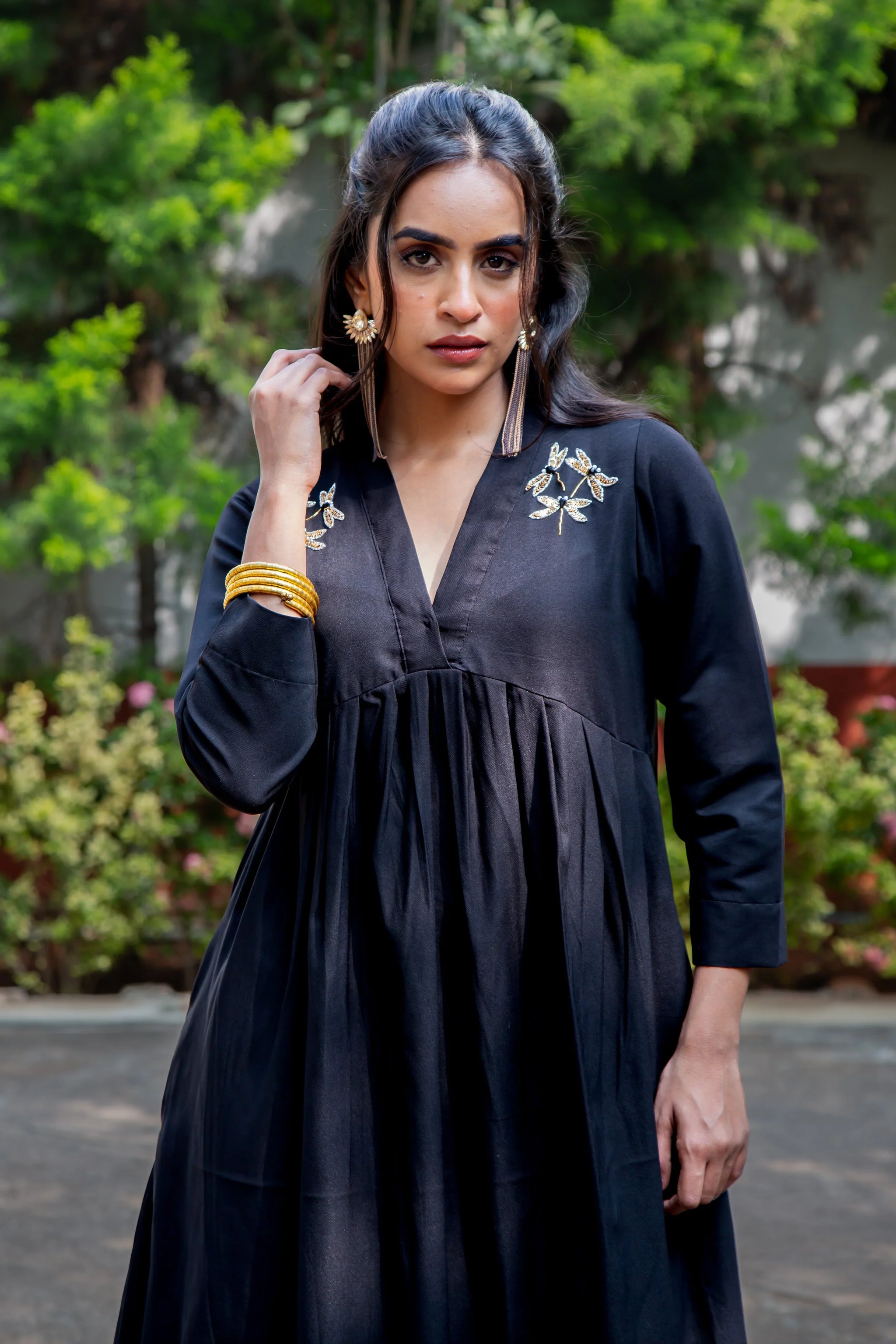 Black embroidered dress with dragonfly details, gold accessories, and V-neck design for women